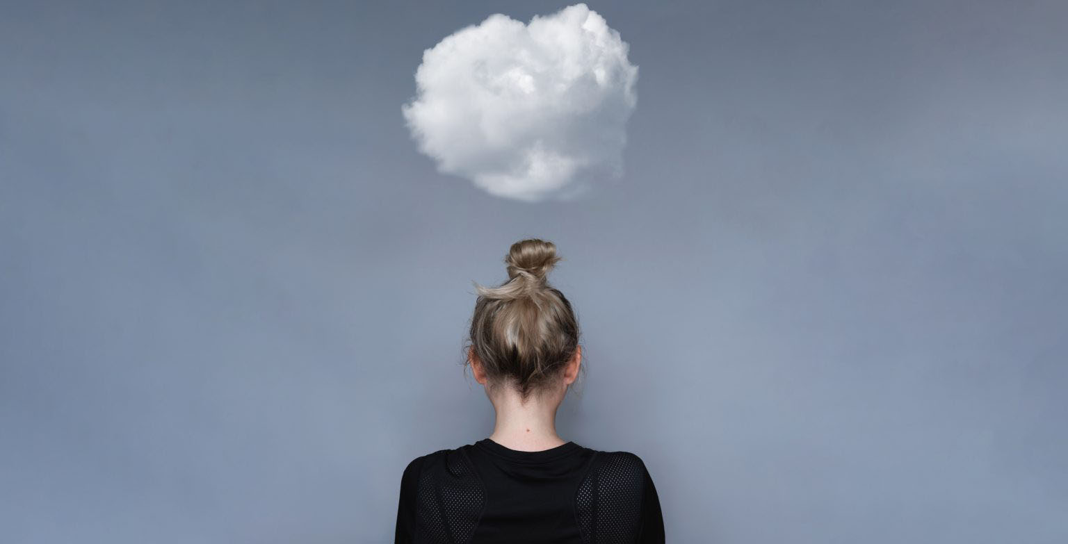 A woman with her head in the clouds.